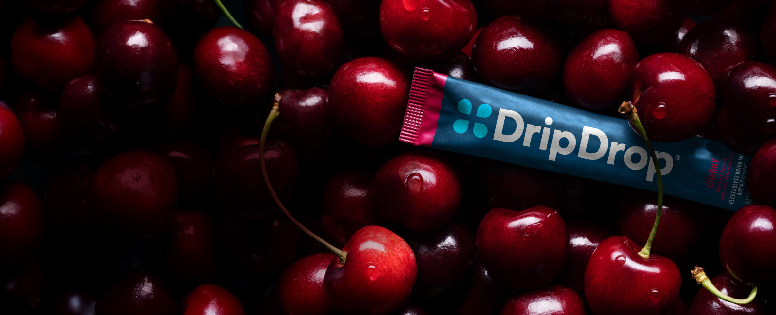 DripDrop Cherry electrolyte pouch among cherries